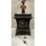 AN EARLY 20TH CENTURY NOVELTY AUTOMATION CARVED DARK OAK MANTLE CLOCK WITH NAPOLEONIC MONKEY