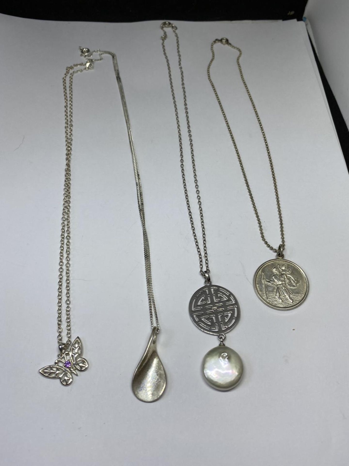 FOUR SILVER NECKLACES WITH PENDANTS