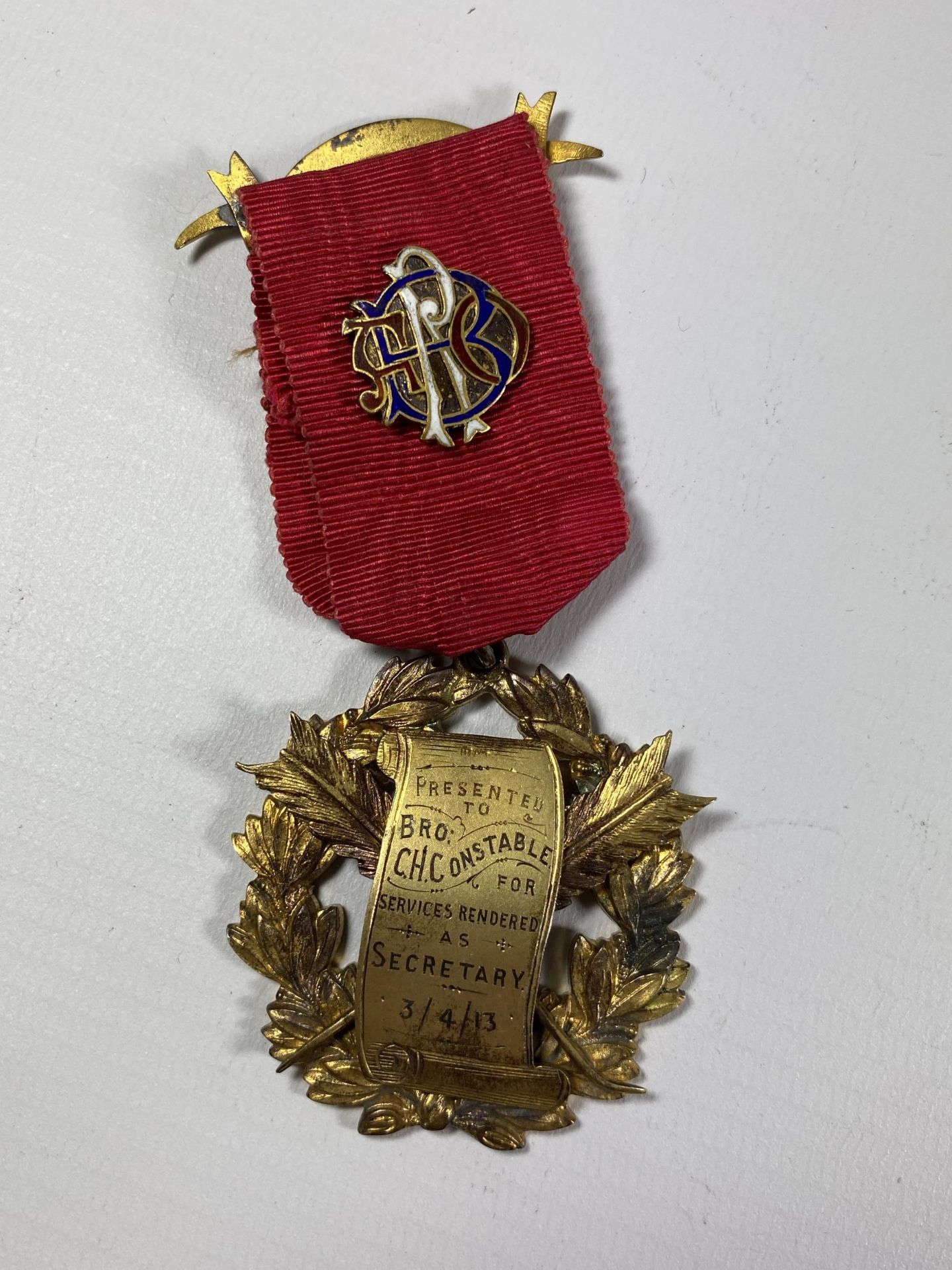 A HALLMARKED SILVER GILT MASONIC MEDAL AND RIBBON