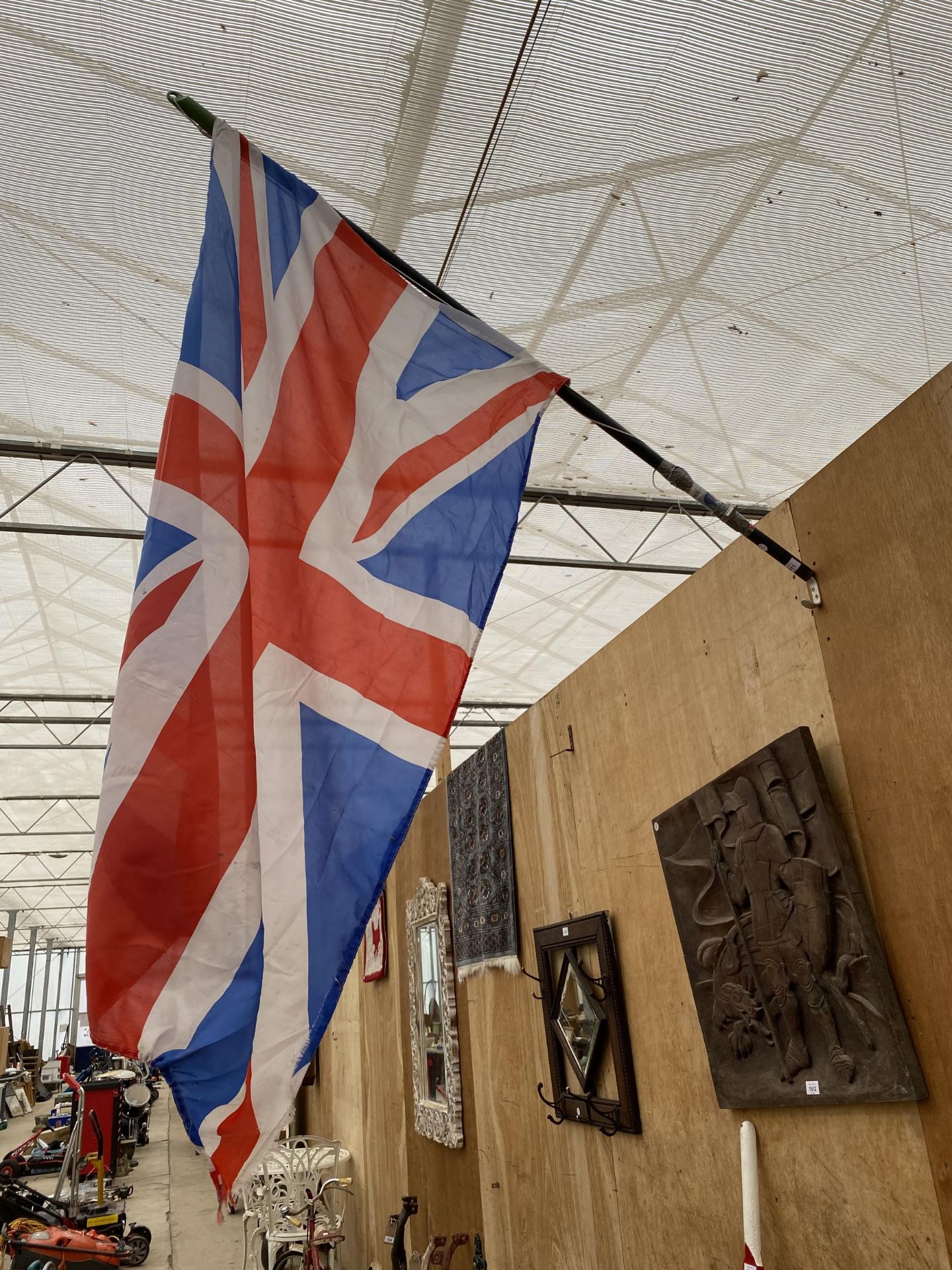 A UNION JACK FLAG WITH PLASTIC POLE