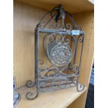 AN ORNATE WROUGHT IRON TWO SECTION WINE BOTTLE HOLDER WITH HINGED LID