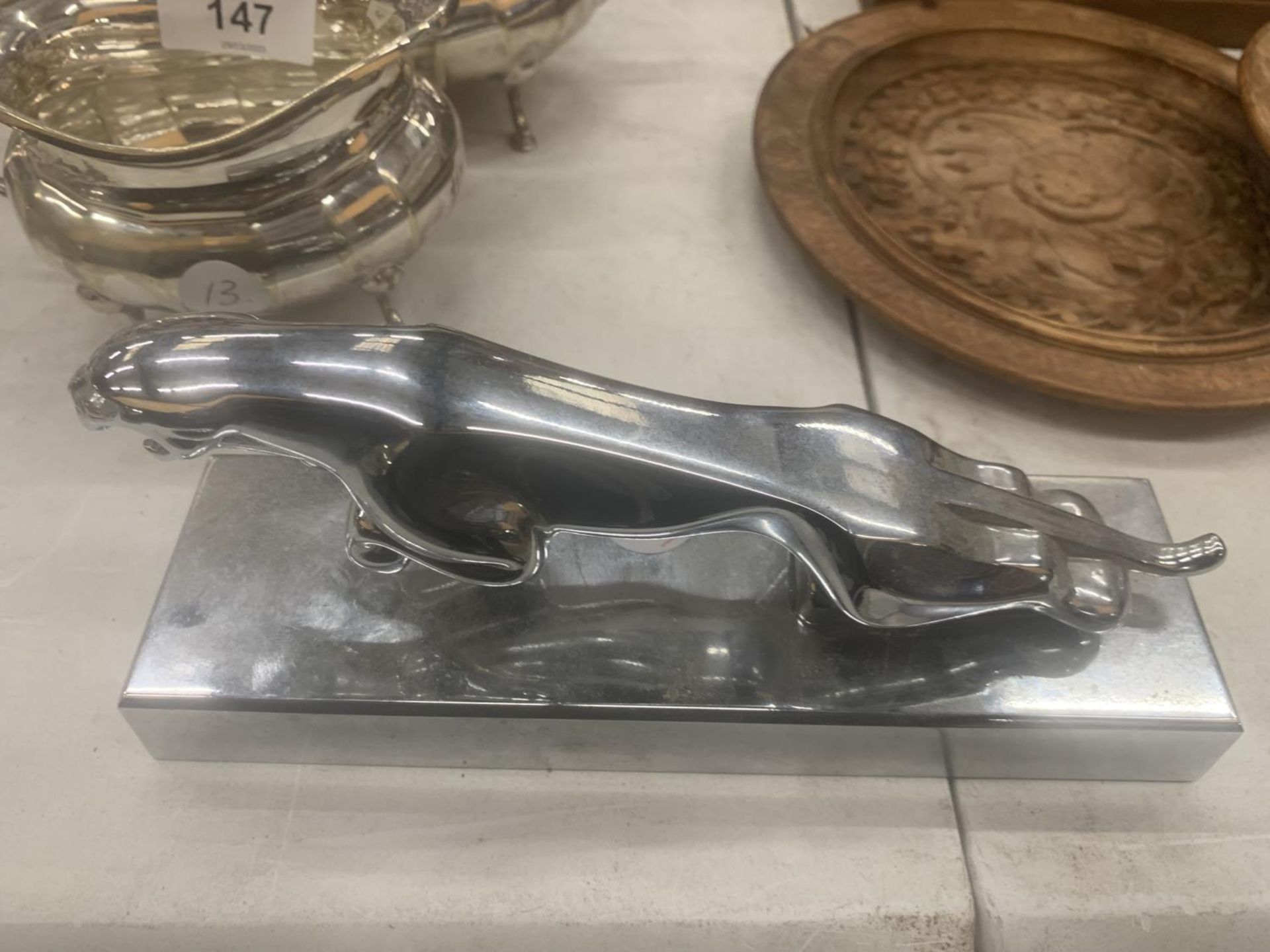 A CHROME MODEL OF A JAGUAR CAR MASCOT