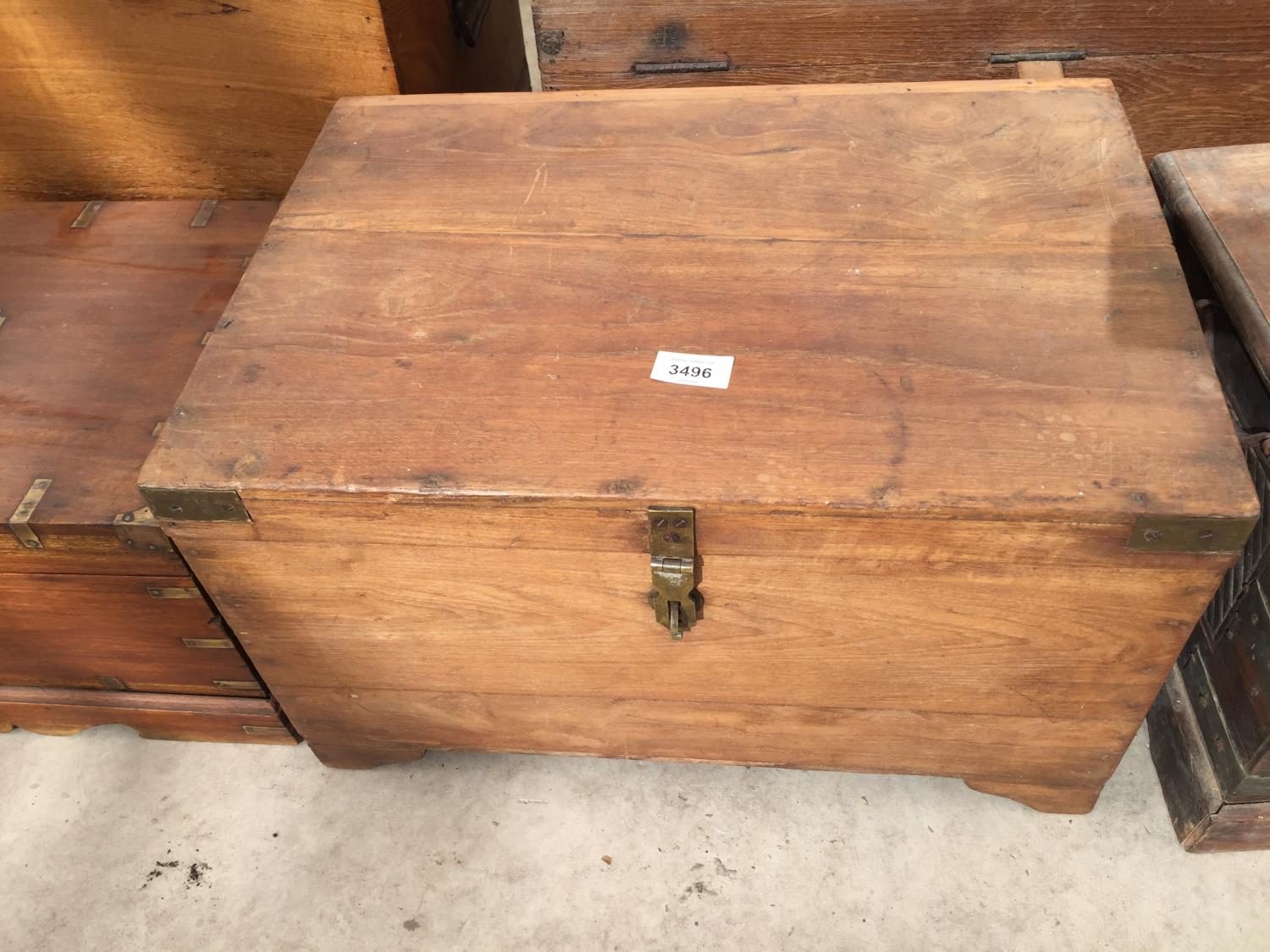 AN INDIAN HARDWOOD BOX WITH BRASS STRAPS, 20" WIDE