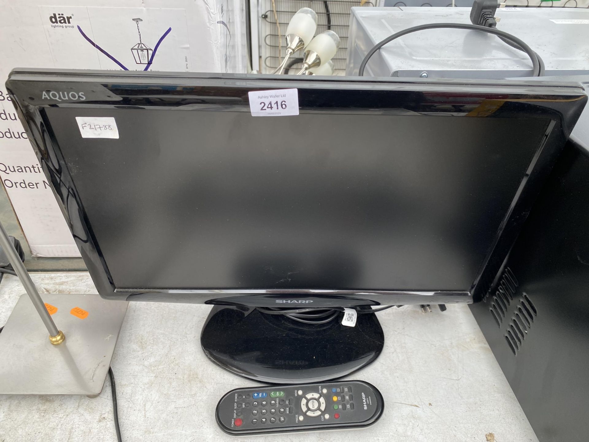 A SHARP 19" TELEVISION WITH REMOTE CONTROL
