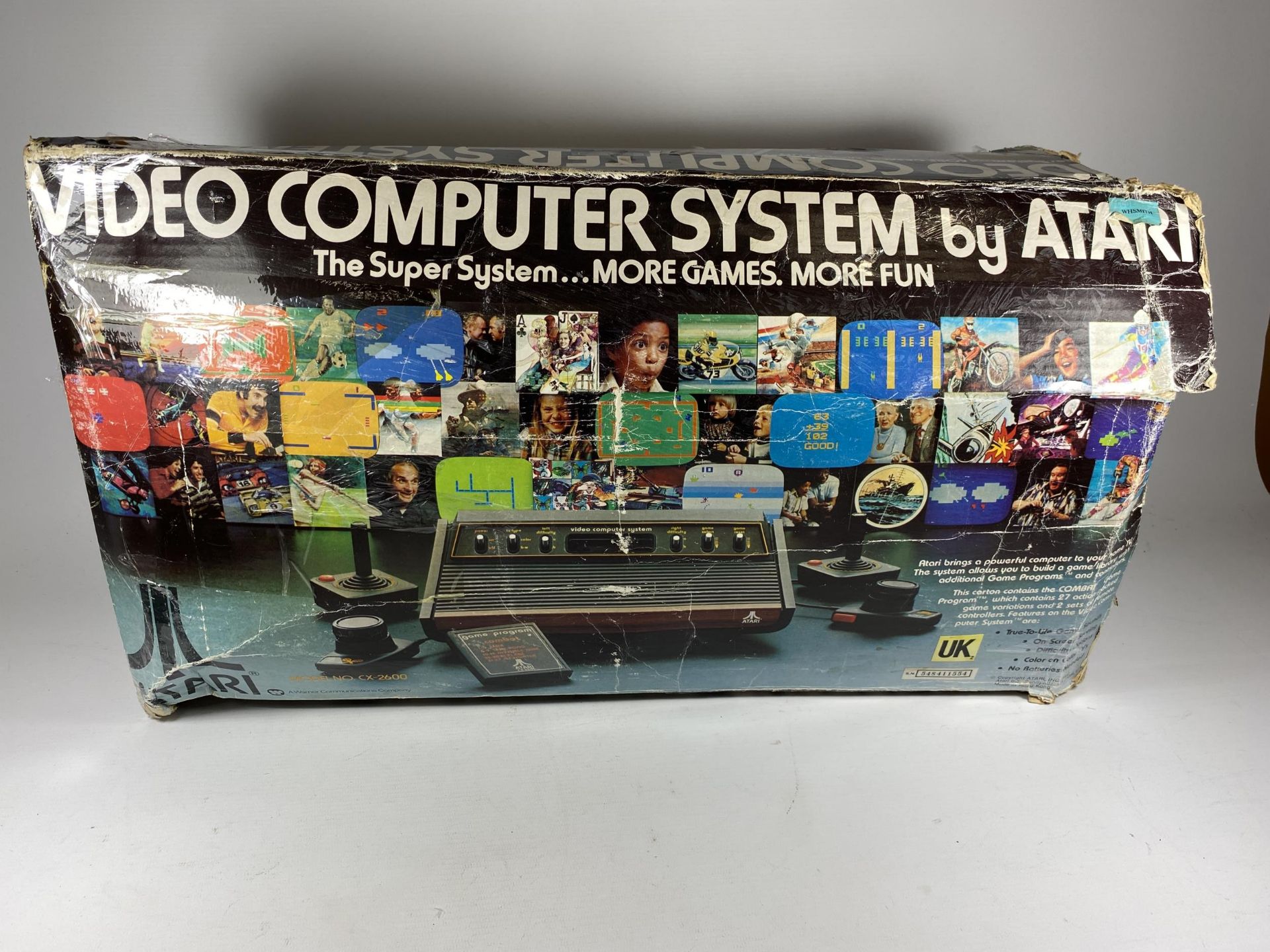 A BOXED RETRO ATARI VIDEO COMPUTER SYSTEM WITH A LARGE QUANTITY OF GAMES