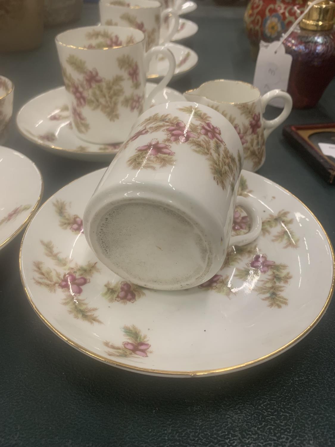 A VINTAGE CHINA PART TEASET WITH PINK FLORAL PATTERN TO INCLUDE CUPS, SAUCERS, CREAM JUG AND A SUGAR - Image 4 of 4