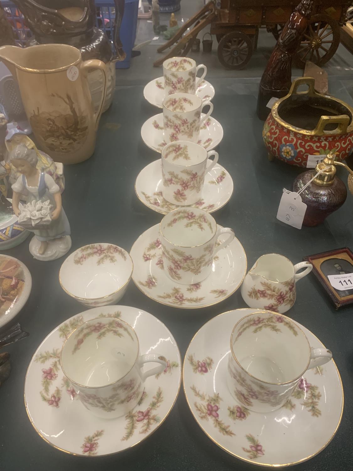 A VINTAGE CHINA PART TEASET WITH PINK FLORAL PATTERN TO INCLUDE CUPS, SAUCERS, CREAM JUG AND A SUGAR