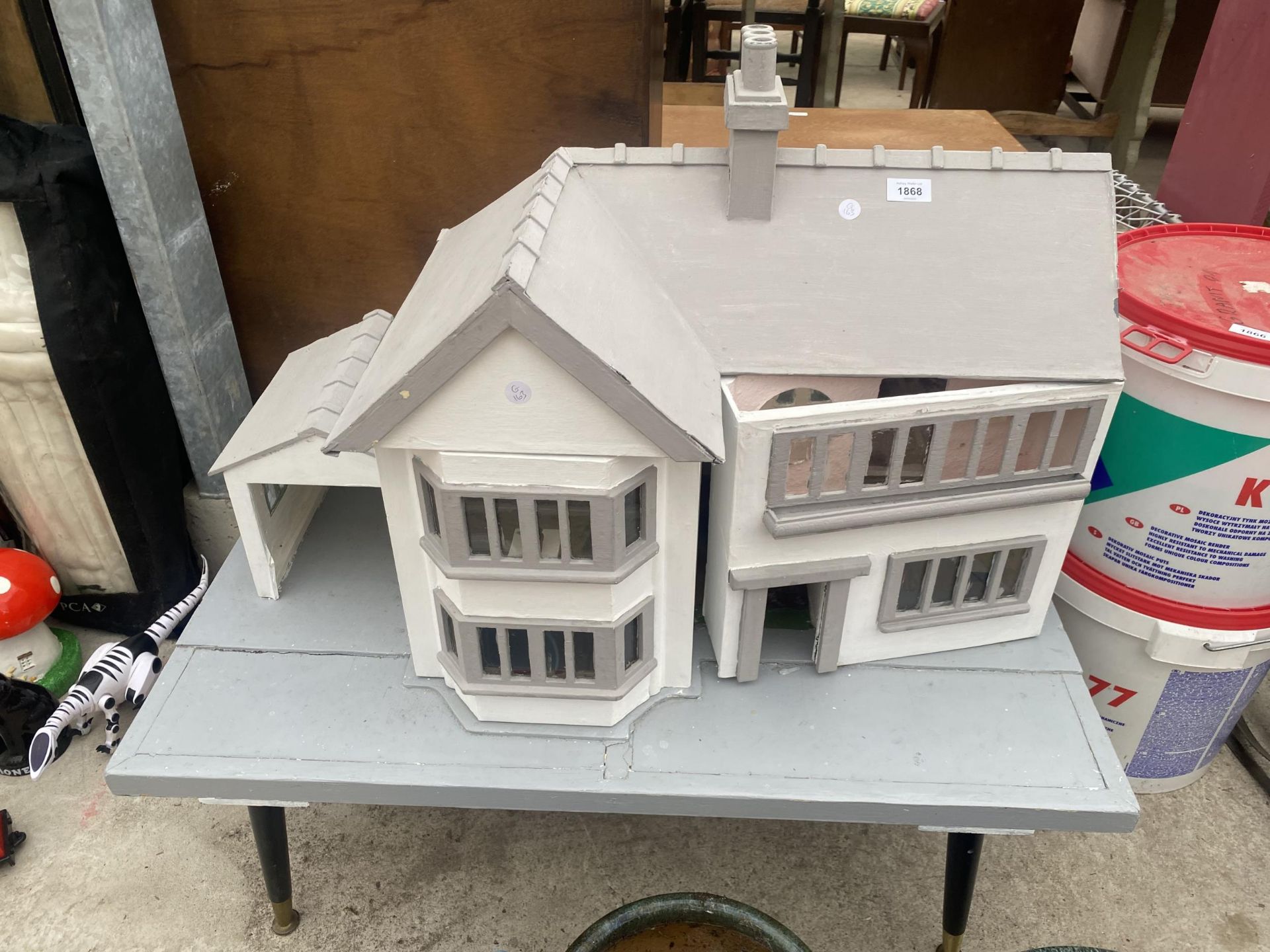 A VINTAGE WOODEN DOLLS HOUSE