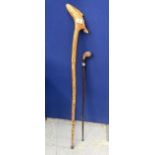 TWO WALKING STICKS TO INCLUDE A WHITE METAL FERRULE EXAMPLE AND CARVED FISH DESIGN EXAMPLE