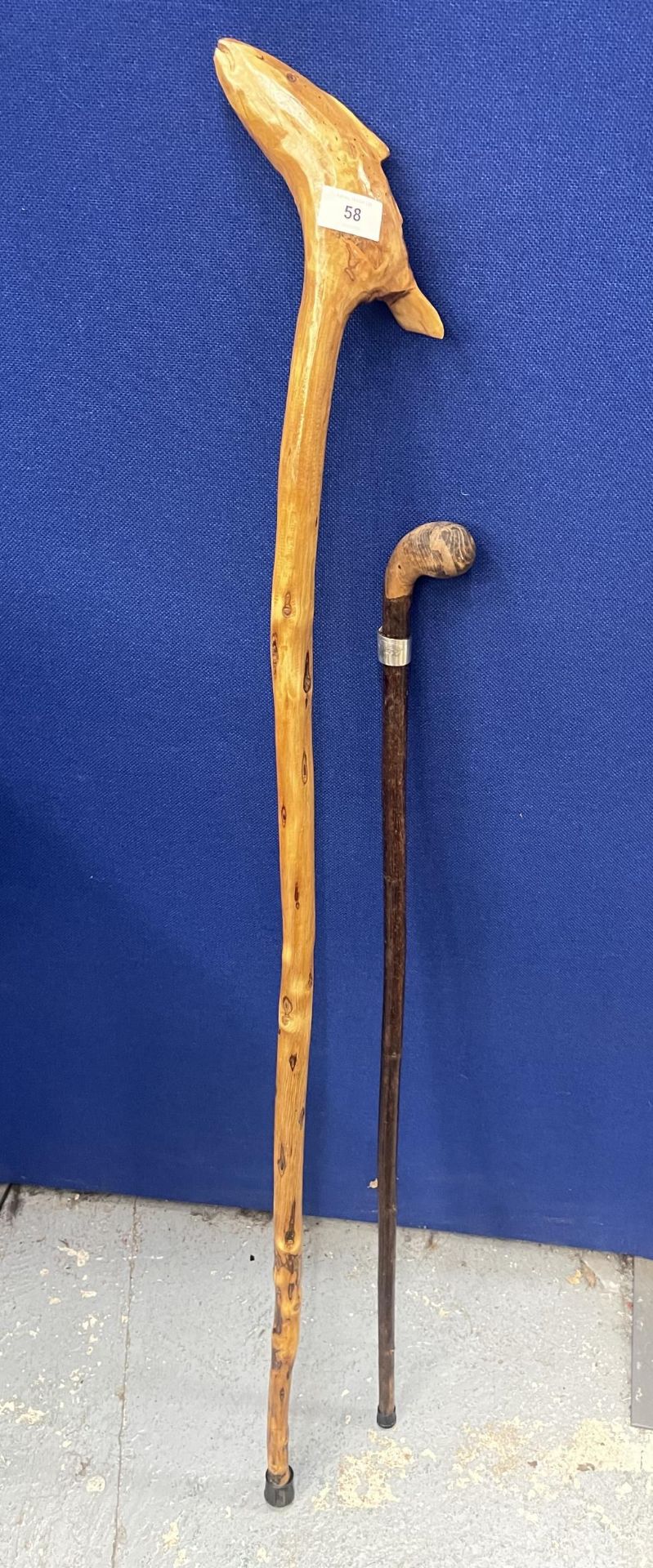 TWO WALKING STICKS TO INCLUDE A WHITE METAL FERRULE EXAMPLE AND CARVED FISH DESIGN EXAMPLE