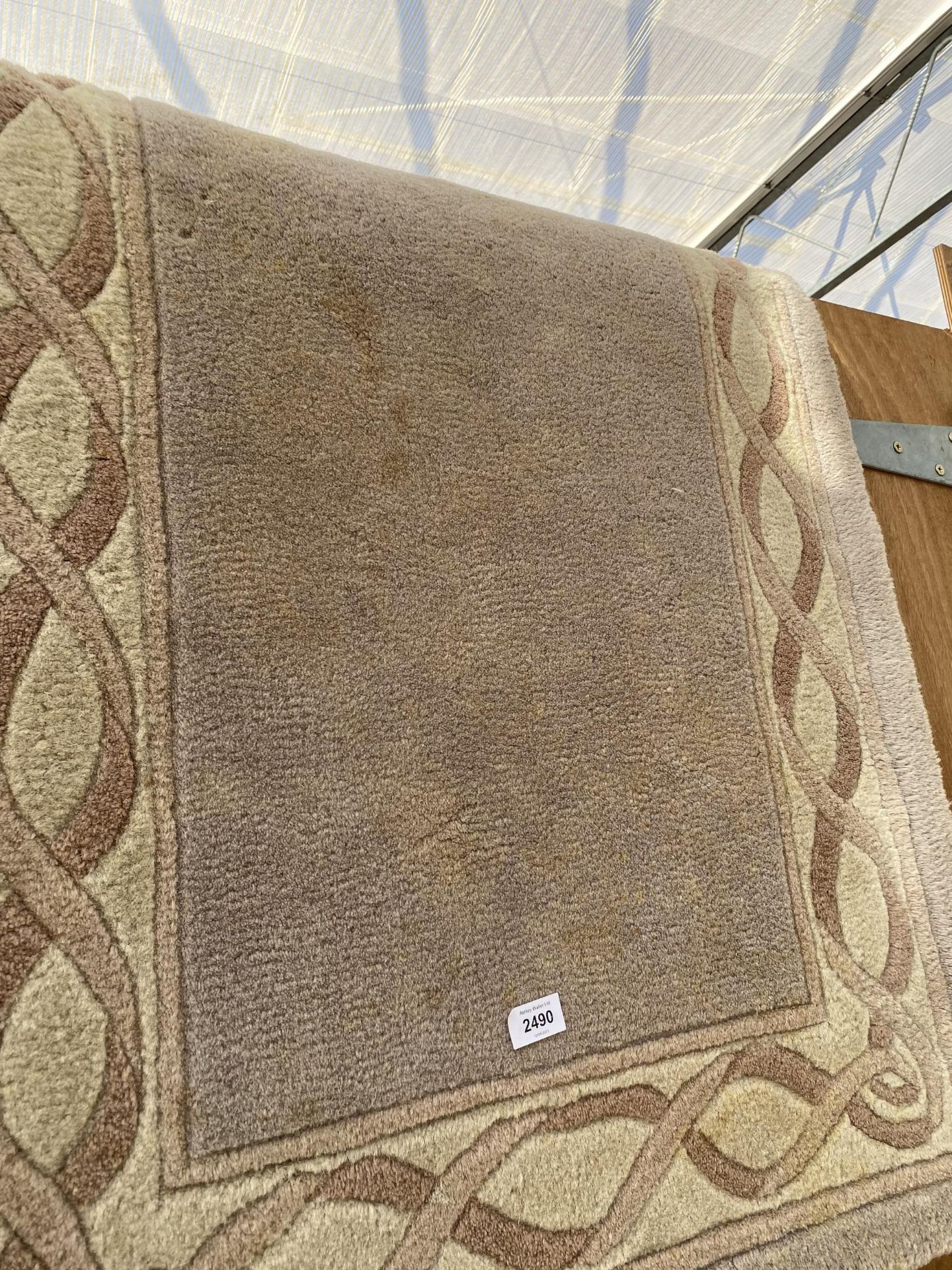 A SMALL CREAM PATTERNED RUG - Image 2 of 2