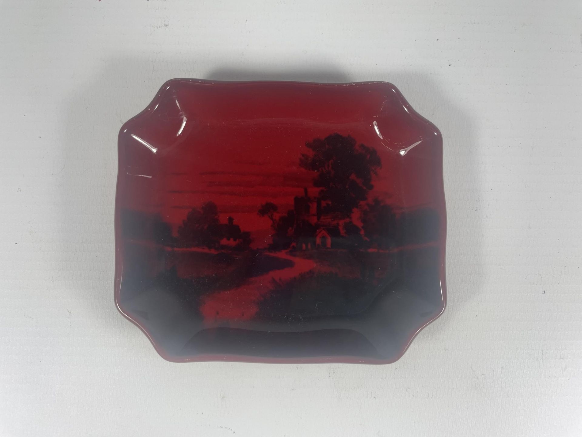 A ROYAL DOULTON FLAMBE DISH WITH COUNTRYSIDE SCENE