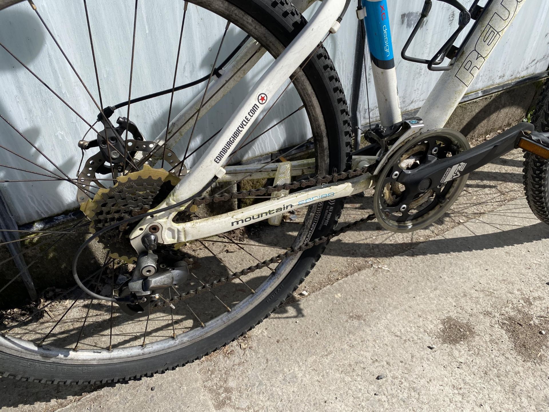 A REVOLUTION MOUNTAIN BIKE WITH FRONT SUSPENSION, DISC BRAKES AND A 24 SPEED SHIMANO GEAR SYSTEM - Image 3 of 3