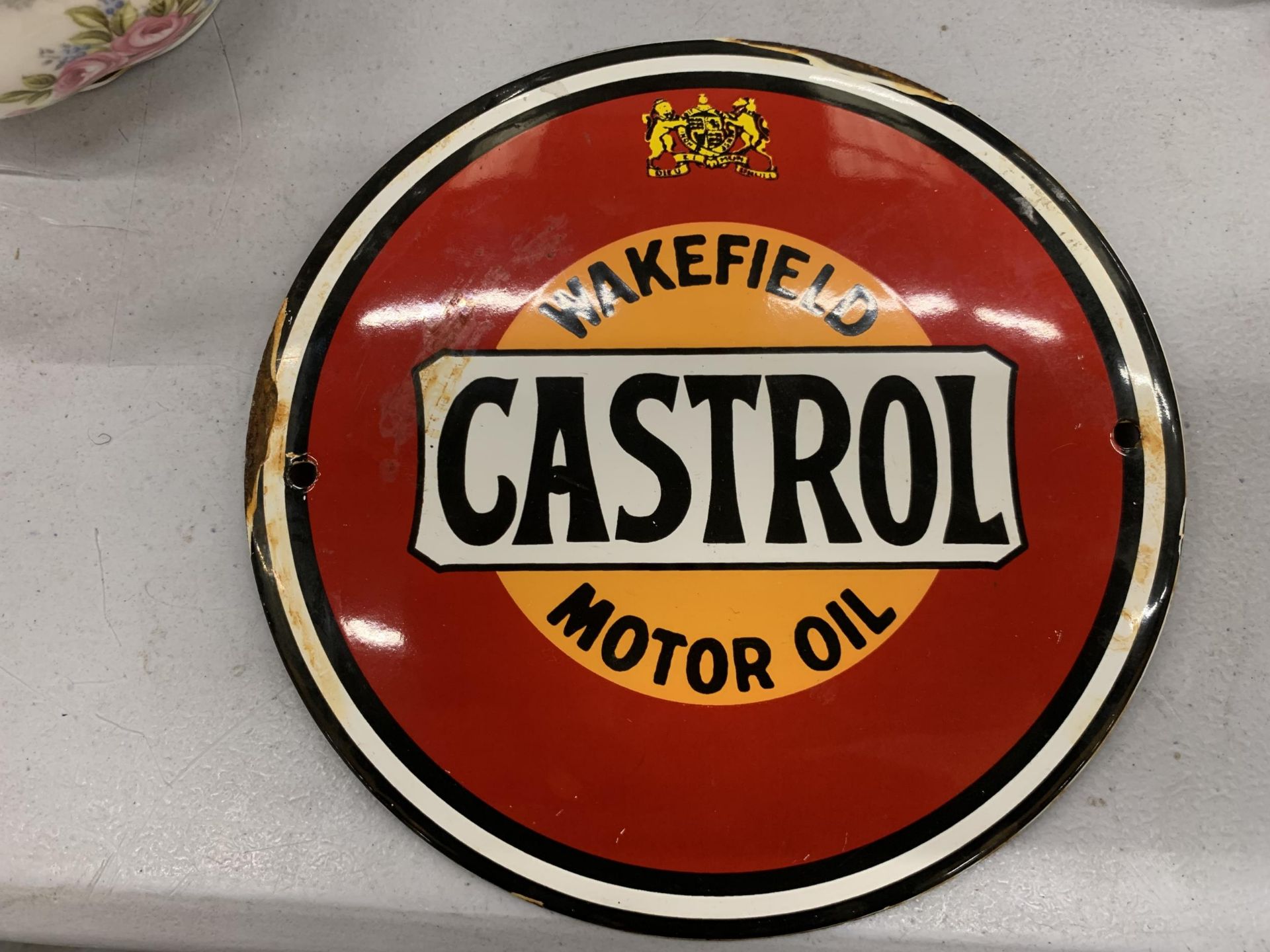 A SMALL ENAMEL SIGN ''WAKEFIELD CASTROL MOTOR OIL' DIAMETER 15CM