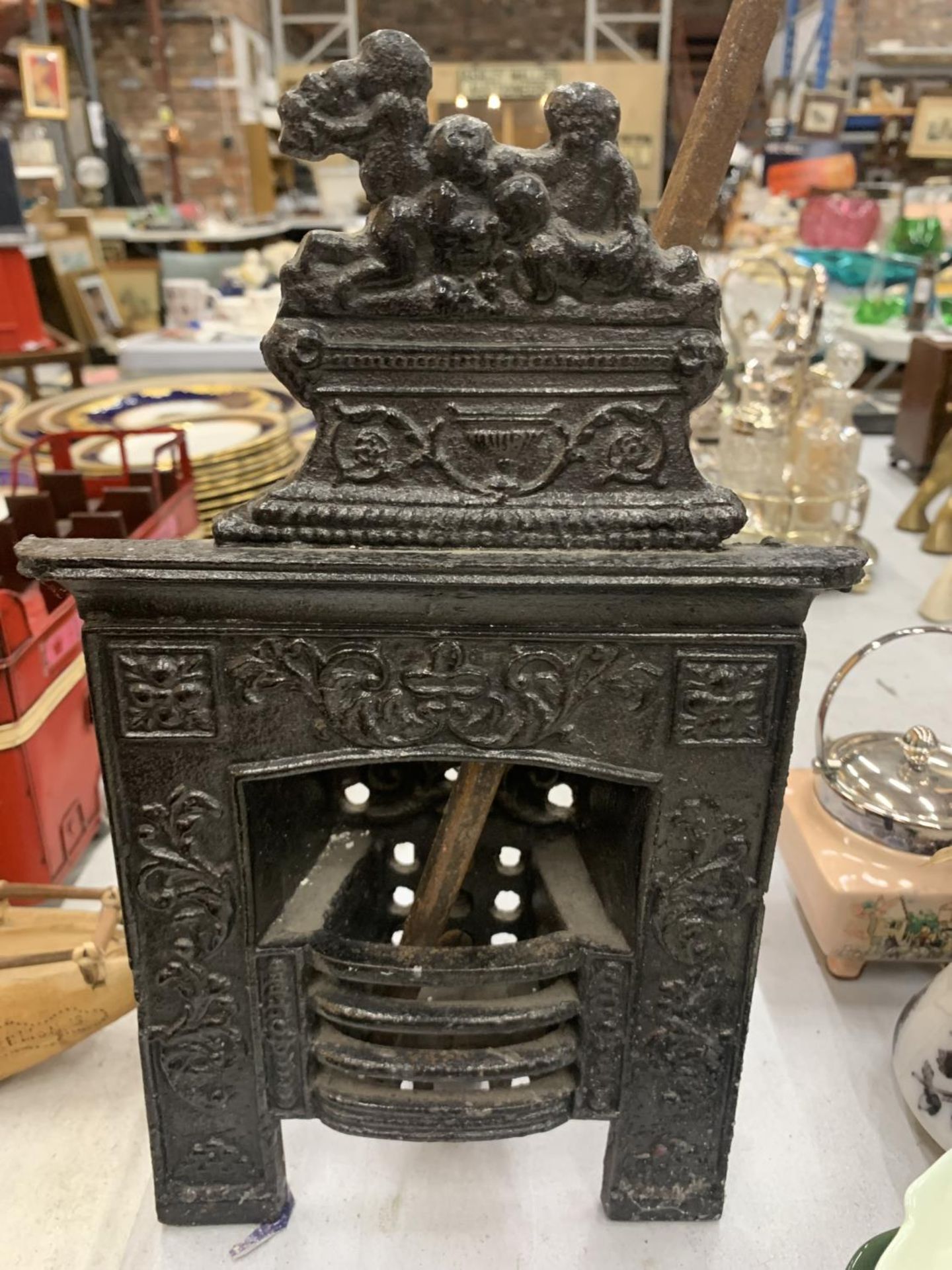 A VINTAGE MINIATURE CAST FIREPLACE WITH POKER HEIGHT 31CM, WIDTH 19CM - Image 3 of 3