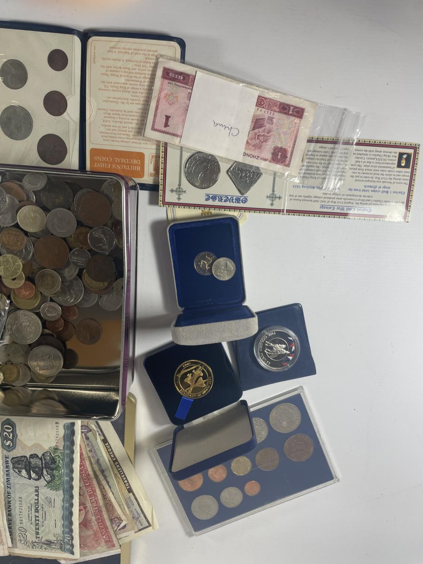 TIN CONTAINING AN ASSORTMENT OF WORLD COINS AND BANKNOTES , TO INCLUDE CHINA , FALKLANDS , IOM - Image 2 of 10