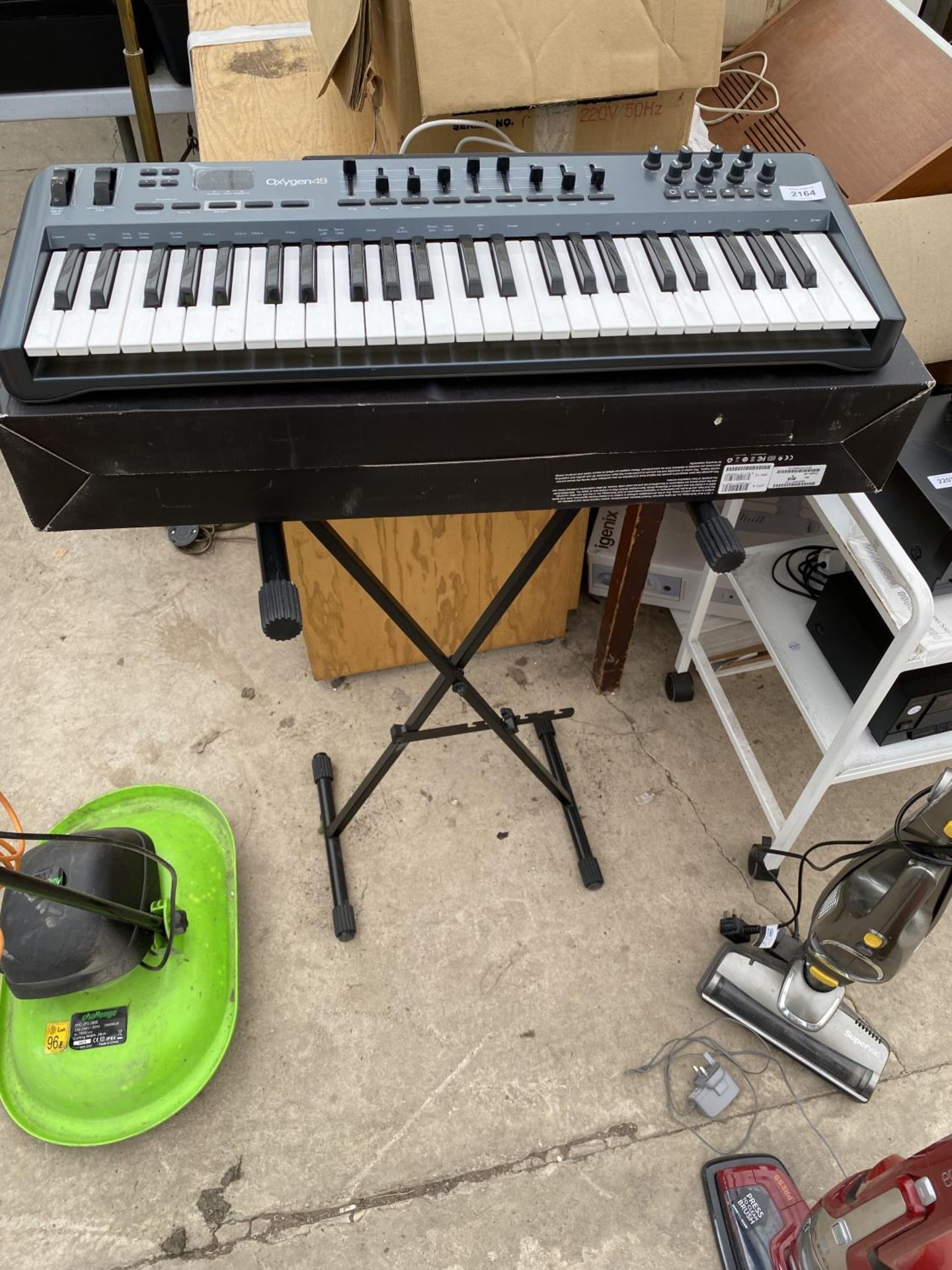 AN OXYGEN 49 ELECTRIC KEYBOARD AND STAND