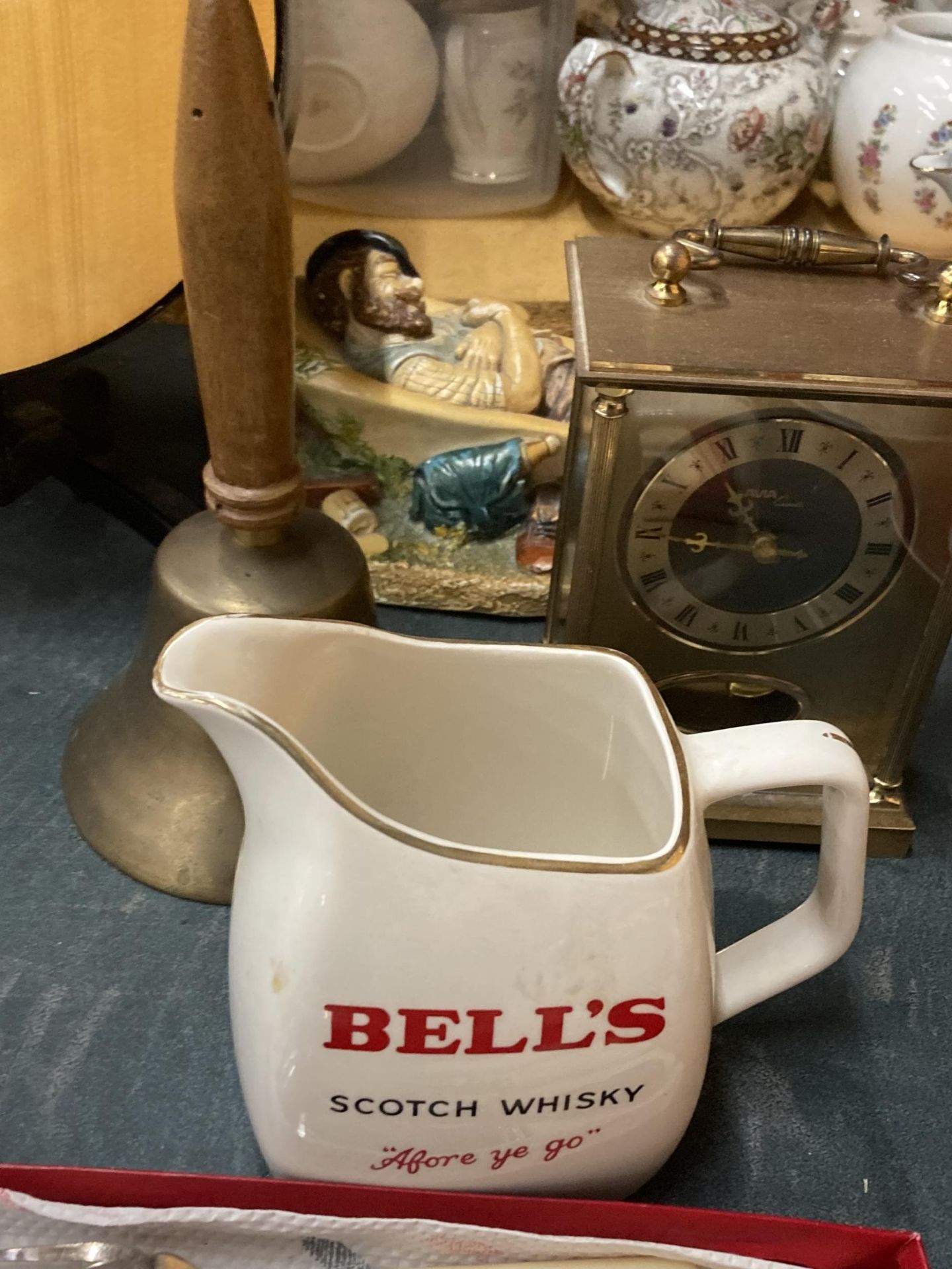 A MIXED LOT TO INCLUDE FLATWARE, A BELL'S WHISKY WATER JUG, BRASS BELL, FIGURE AND MANTLE CLOCK - Image 3 of 4