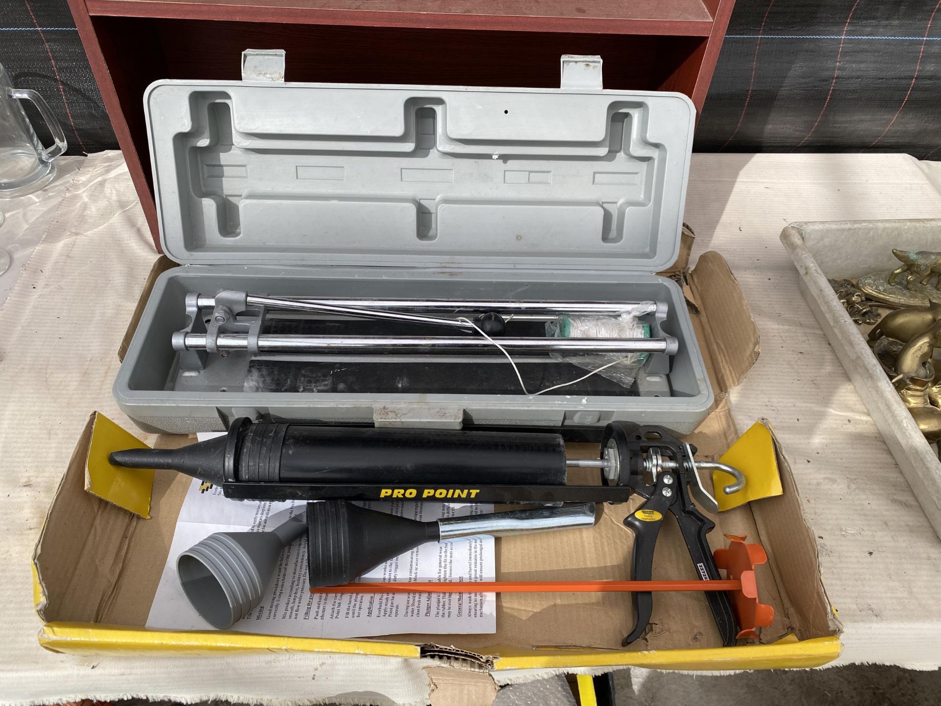 A PRO POINT GUN KIT AND A TILE CUTTER