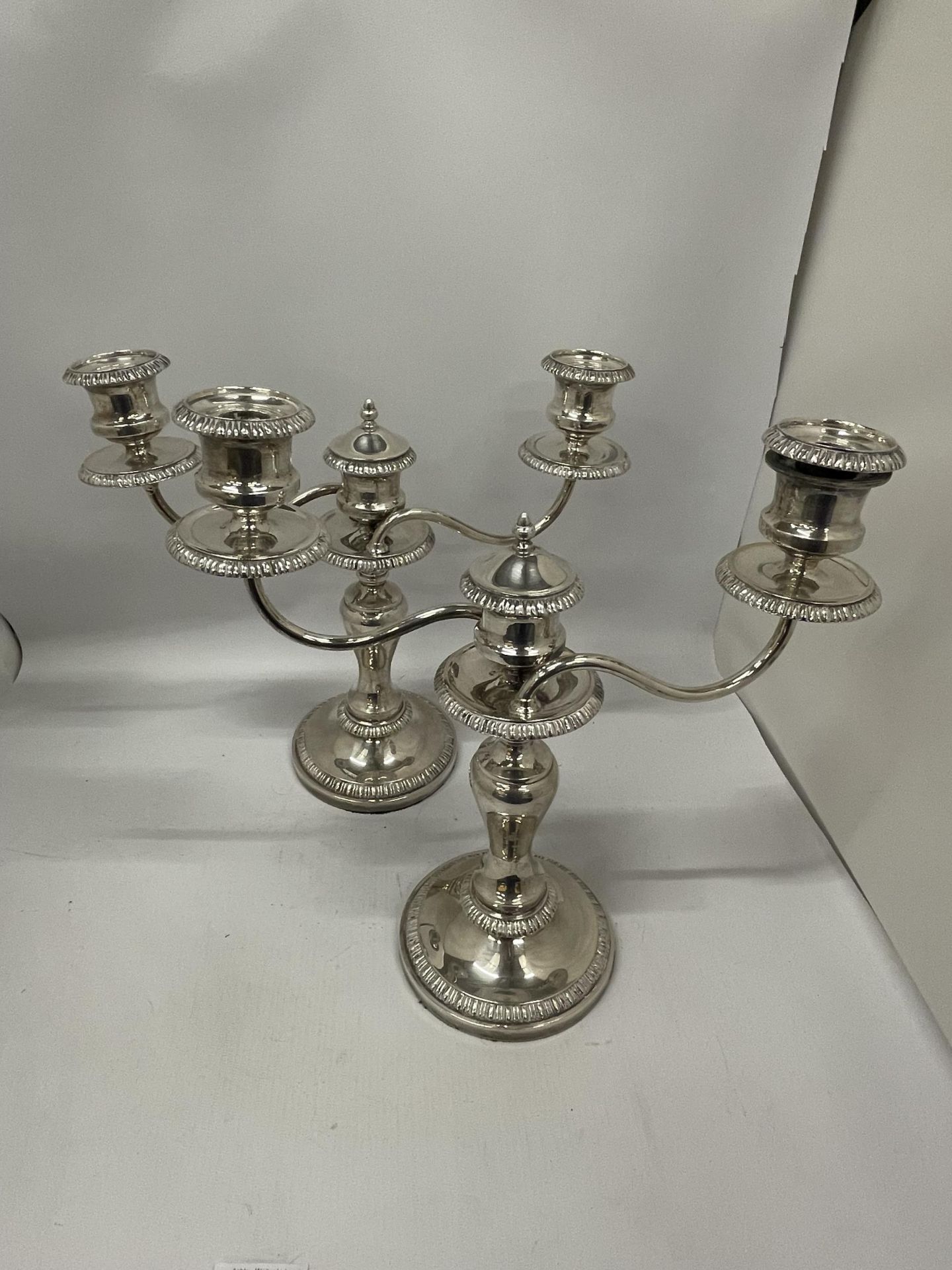 A PAIR OF GOOD QUALITY SILVER PLATED TWIN BRANCH CANDLE HOLDERS