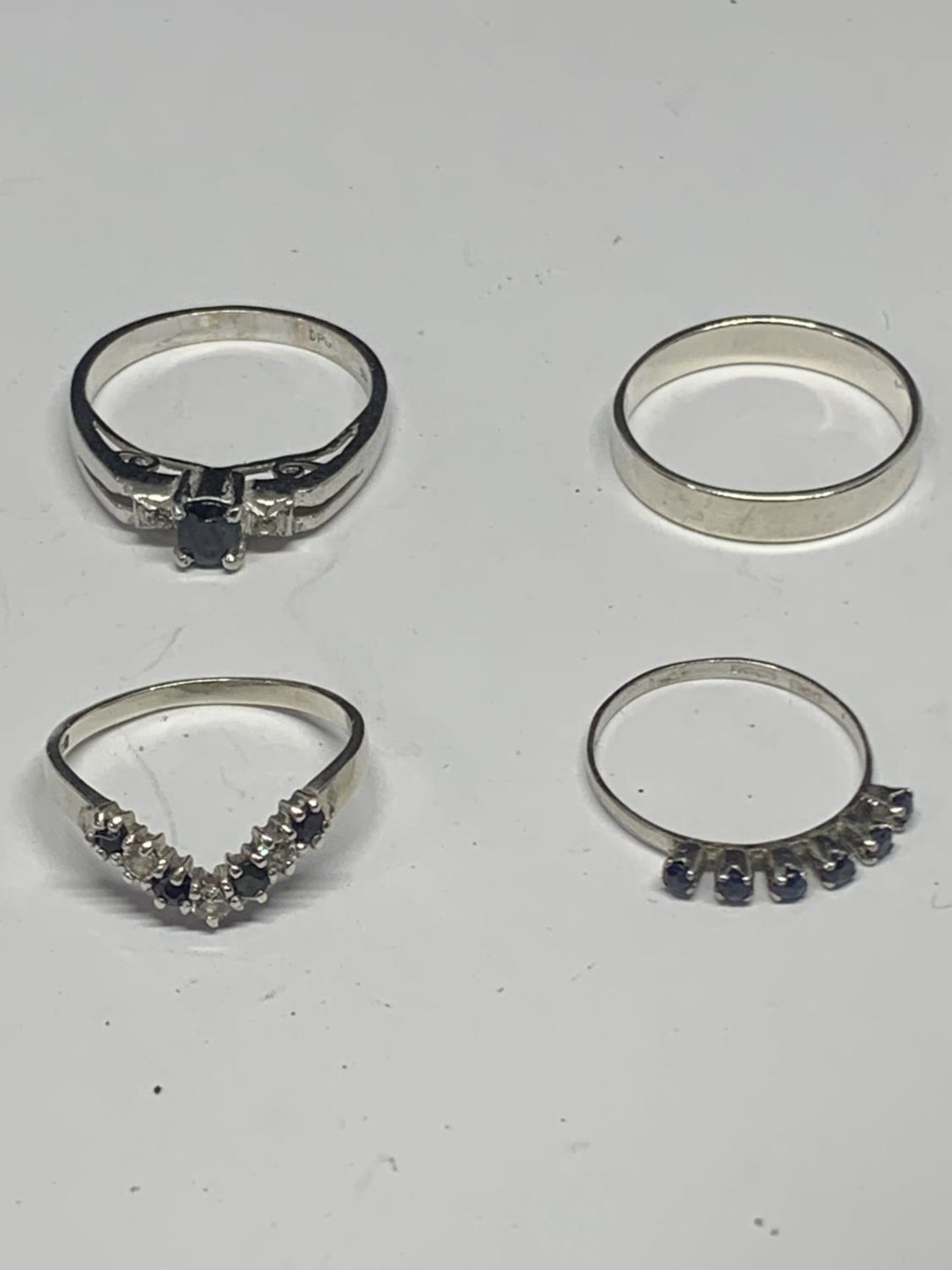 FOUR VARIOUS SILVER RINGS