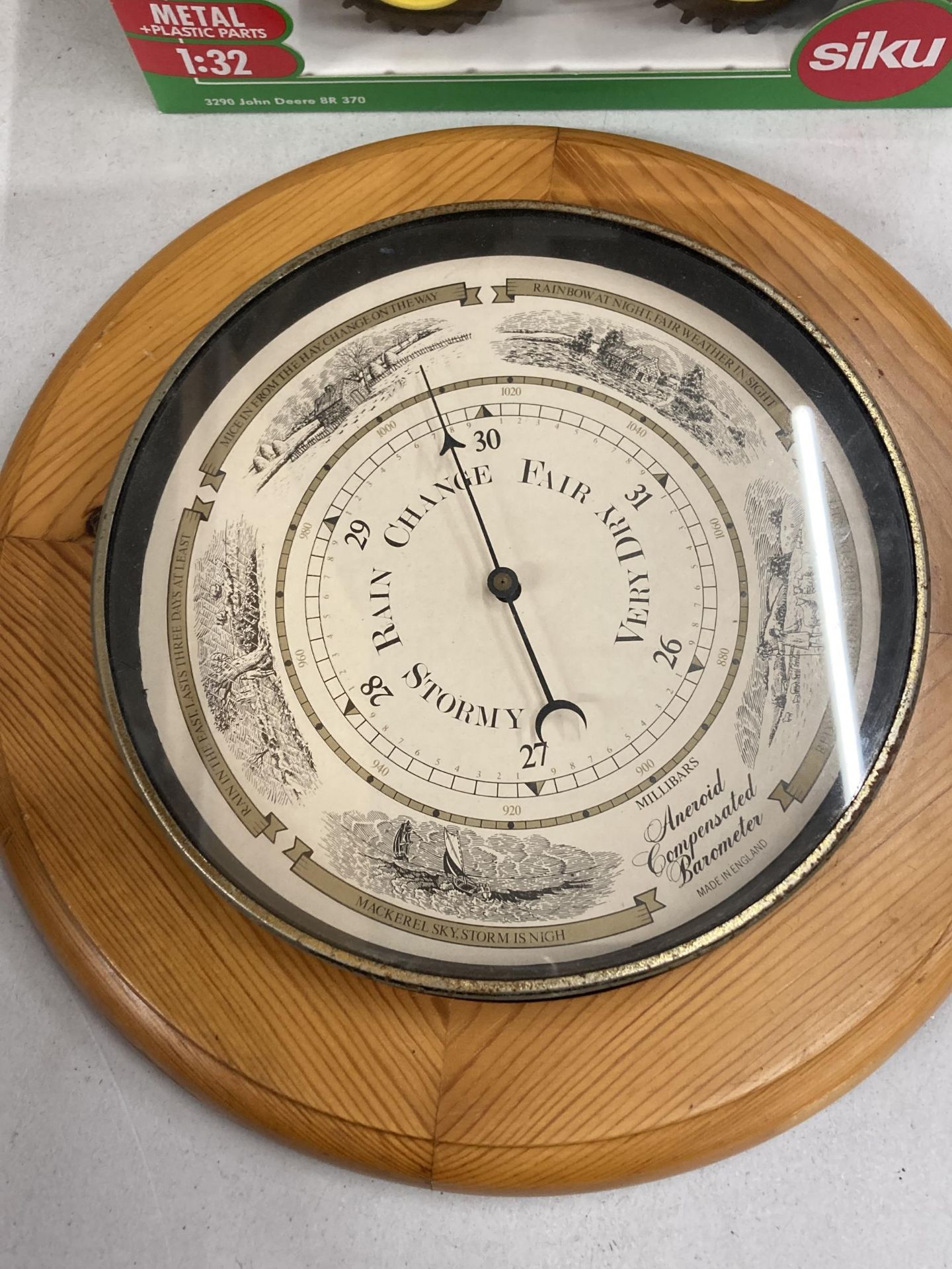 A VINTAGE PINE FRAMED ROUND ANEROID BAROMETER DIAMETER APPROX 30CM