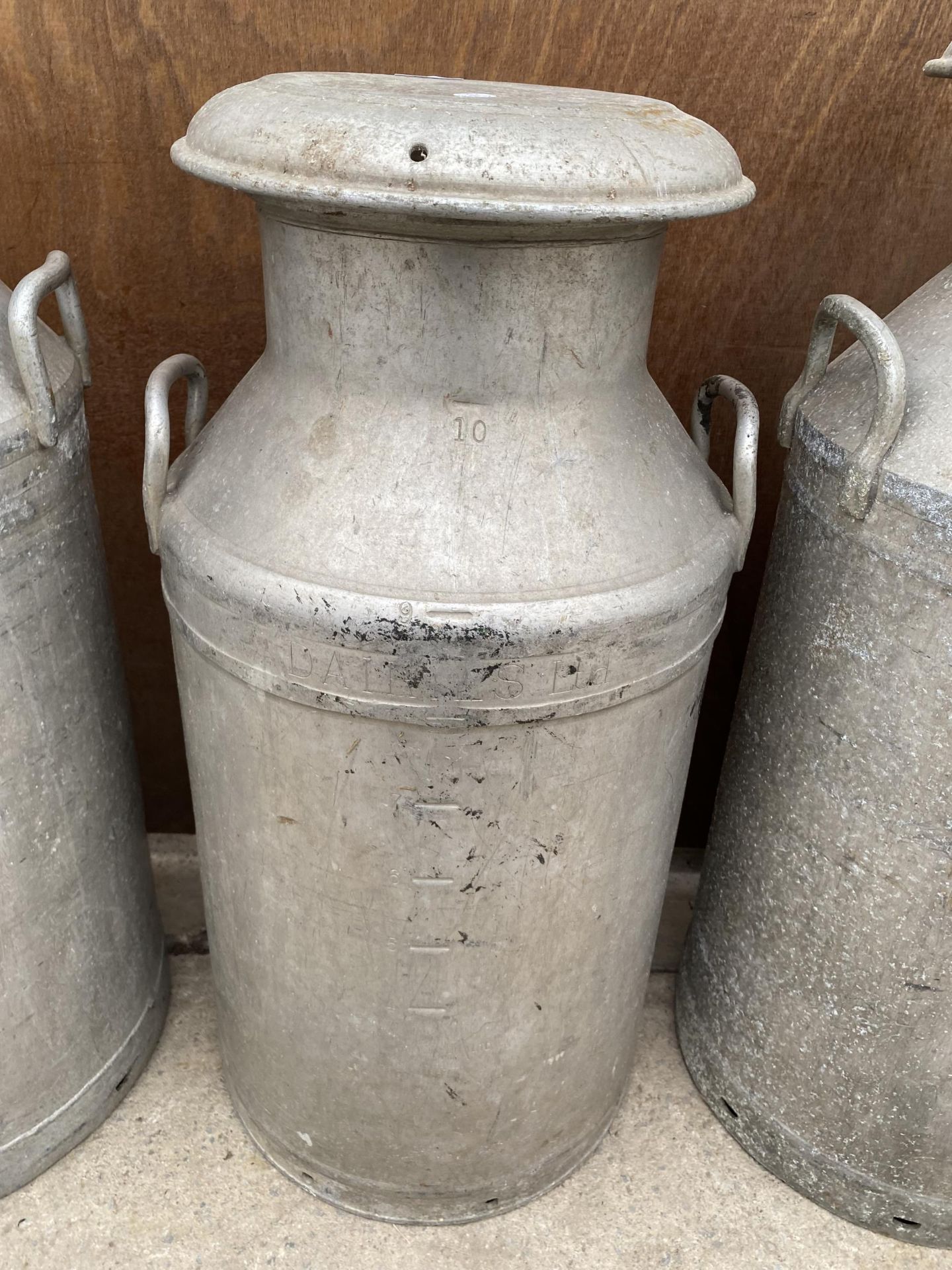 AN ALUMINIUM MILK CHURN COMPLETE WITH LID