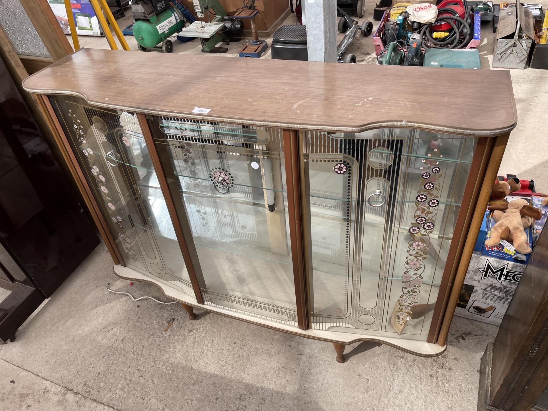 A 1960'S GLASS THREE DOOR CABINET WITH FLORAL DECORATION ON GLASS