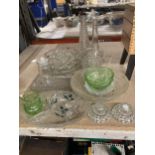 A QUANTITY OF GLASSWARE TO INCLUDE BOWLS, BOTTLES, NIBBLES DISH, CANDLESTICKS, ETC.,