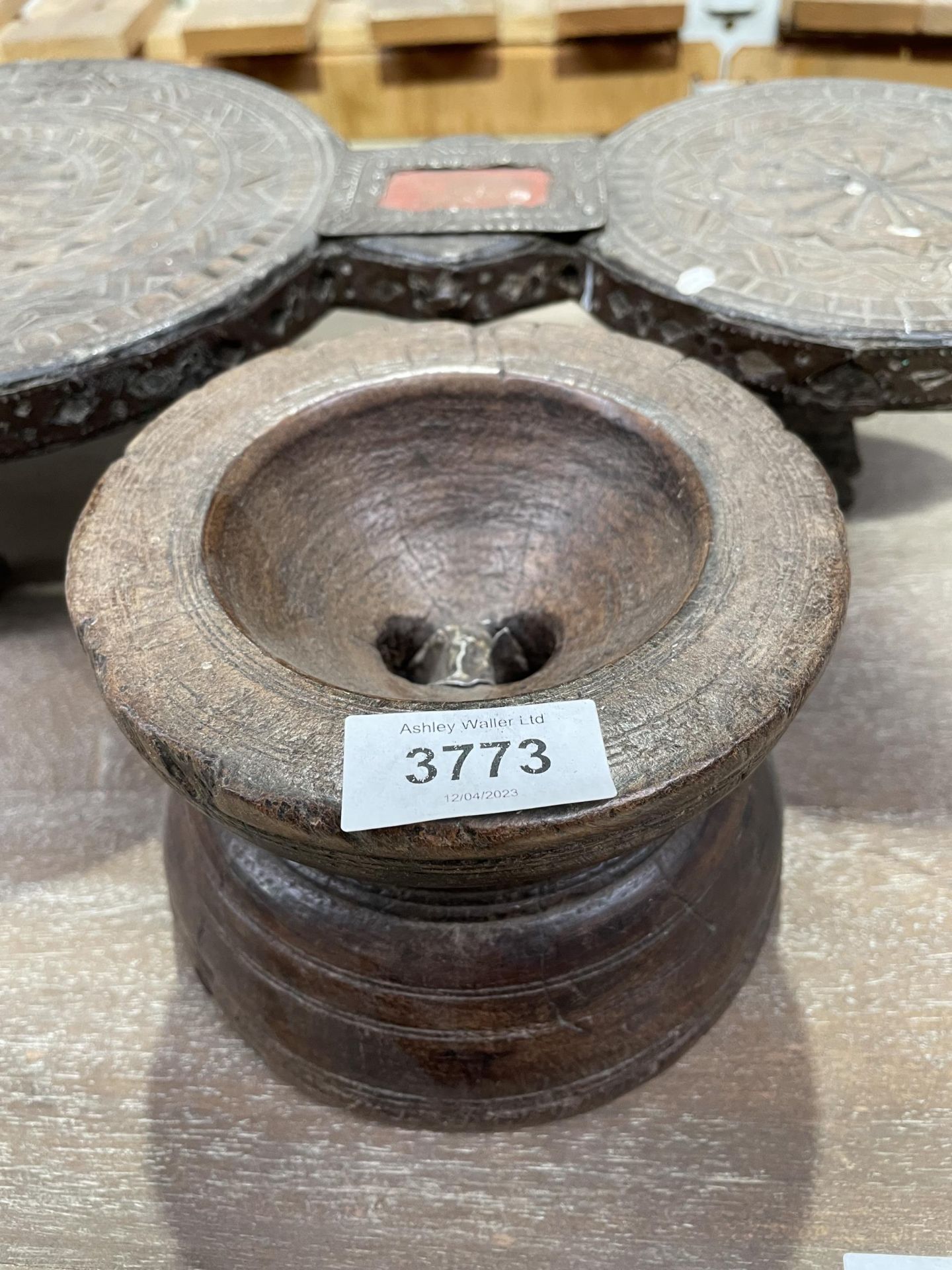 A CARVED INDIAN HARDWOOD STAND AND FURTHER BOWL