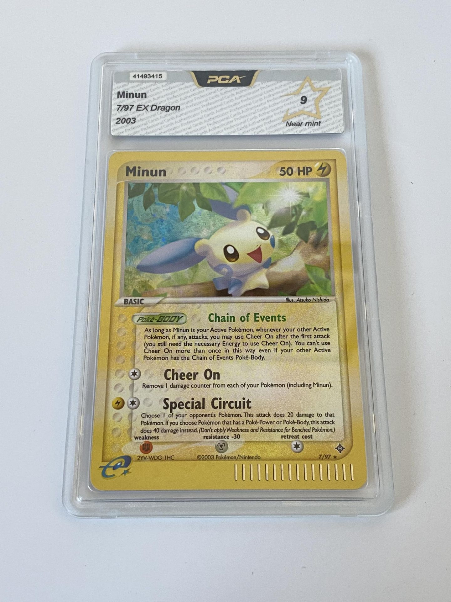 A GRADED POKEMON CARD -MINUN 7/97 EX DRAGON - PCA GRADE - 9