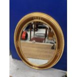A LARGE DECORATIVE GILT EFFECT OVAL MIRROR
