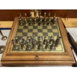 A DECORATIVE CHESS SET WITH LIGHT OAK SURROUND BOARD