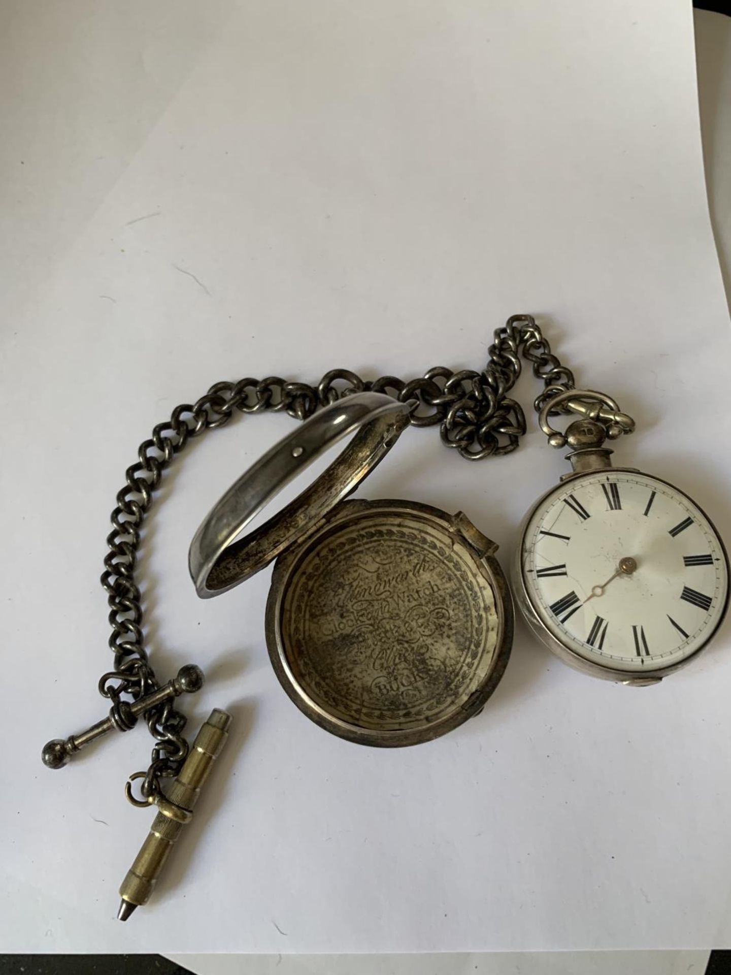 A SILVER POCKET WATCH WITH WHITE METAL CHAIN AND A CASE