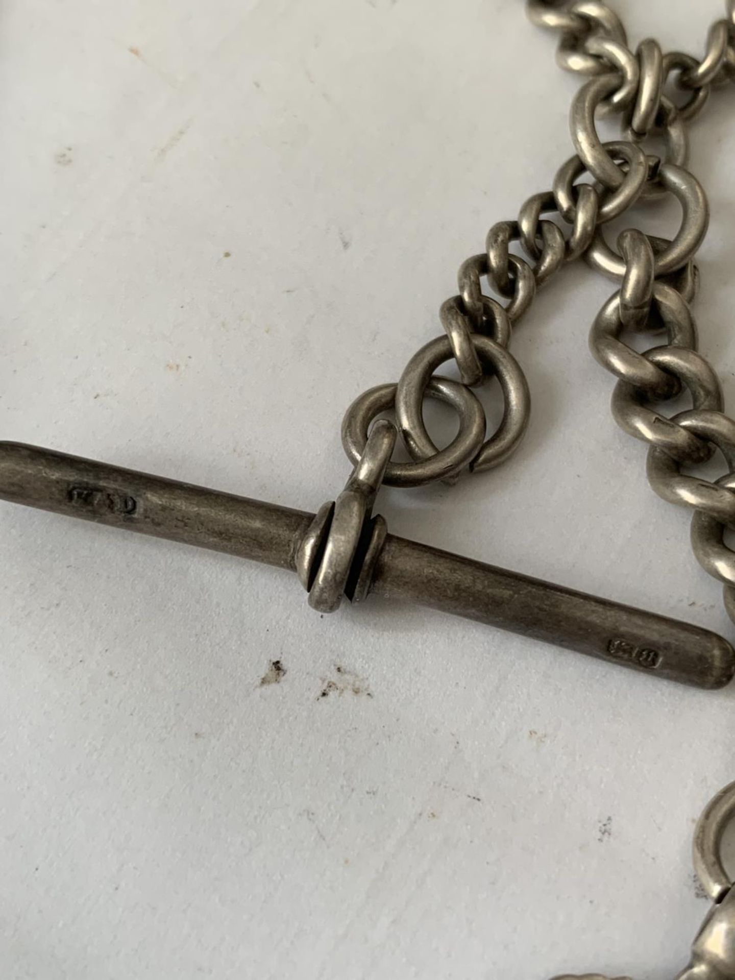A HEAVY SILVER WATCH CHAIN WITH TWO HALLMARKED SILVER FOBS - Image 4 of 5
