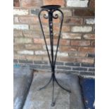 A TALL HEAVY METAL CANDLE HOLDER, HEIGHT 98 CM