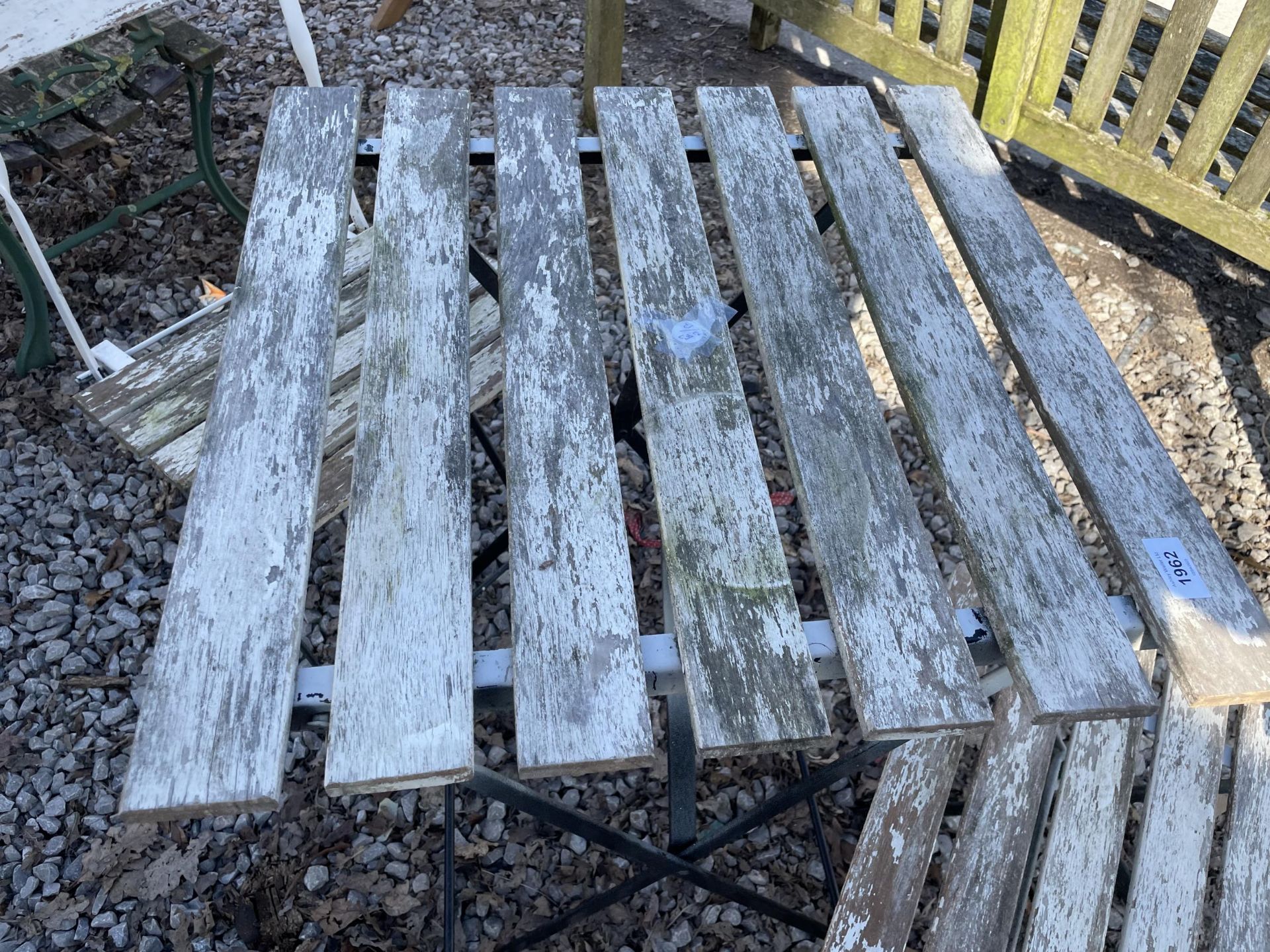 A METAL AND WOODEN SLATTED FOLDING BISTRO SET COMPRISING OF A SQUARE TABLE AND TWO CHAIRS - Image 2 of 2