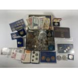 TIN CONTAINING AN ASSORTMENT OF WORLD COINS AND BANKNOTES , TO INCLUDE CHINA , FALKLANDS , IOM