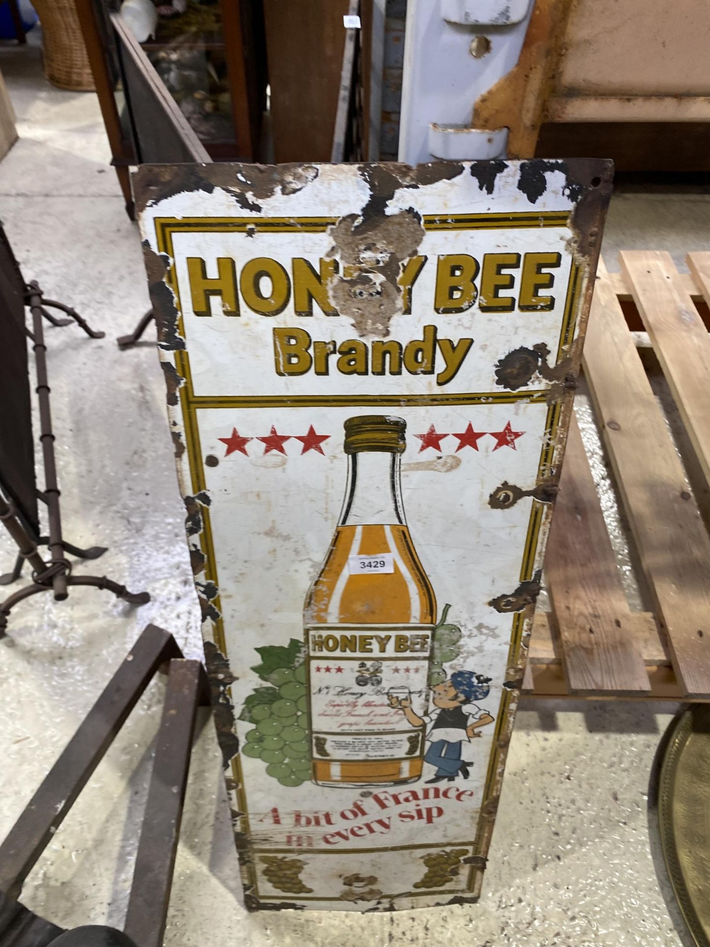 A VINTAGE HONEY BEE BRANDY SIGN, 36.5" HIGH (WORN)