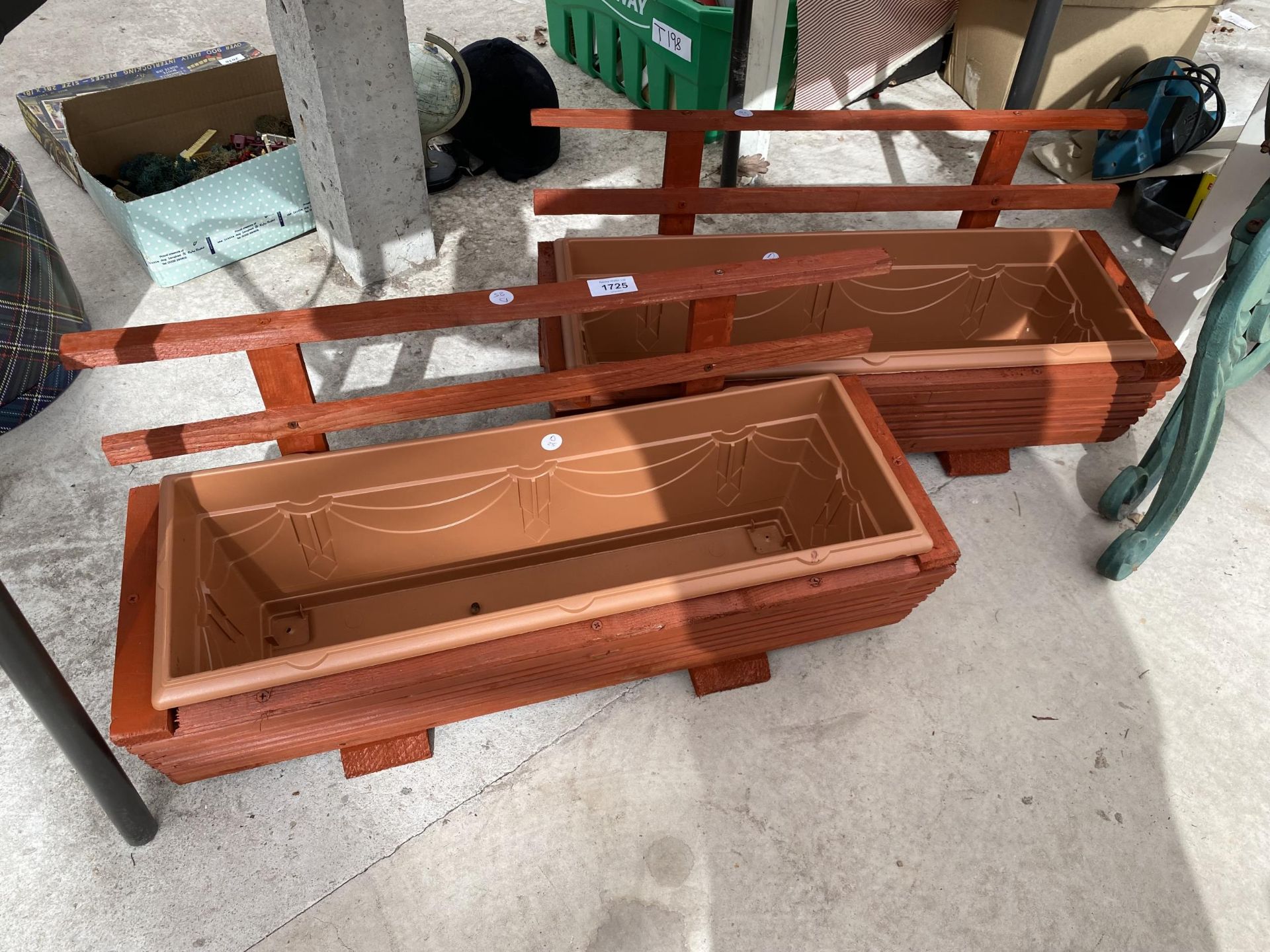 TWO WOODEN TROUGH PLANTERS WITH PLASTIC INSERTS AND TRELIS BACKS