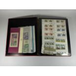 A STAMP ALBUM CONTAINING A LARGE QUANTITY OF BRITISH MINT STAMPS