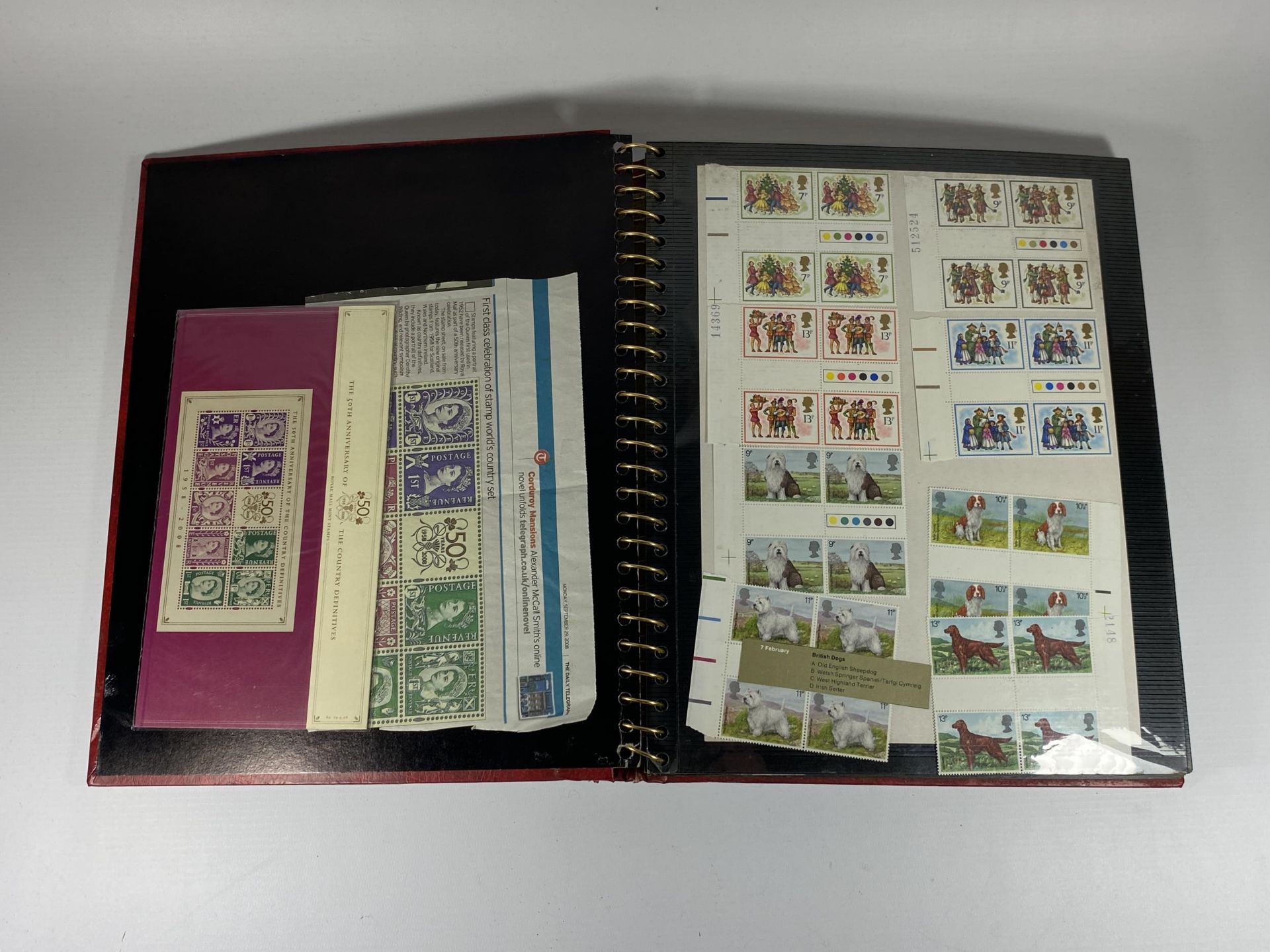 A STAMP ALBUM CONTAINING A LARGE QUANTITY OF BRITISH MINT STAMPS