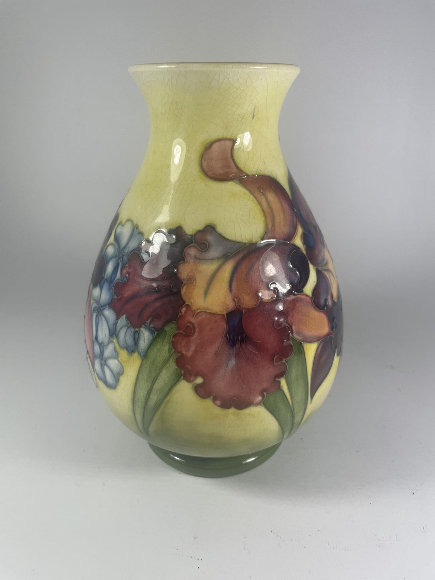 A WALTER MOORCROFT FLORAL ORCHID PATTERN BALUSTER VASE ON YELLOW GROUND (SOME CRAZING)