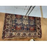 A VINTAGE PATTERNED FRINGED RUG