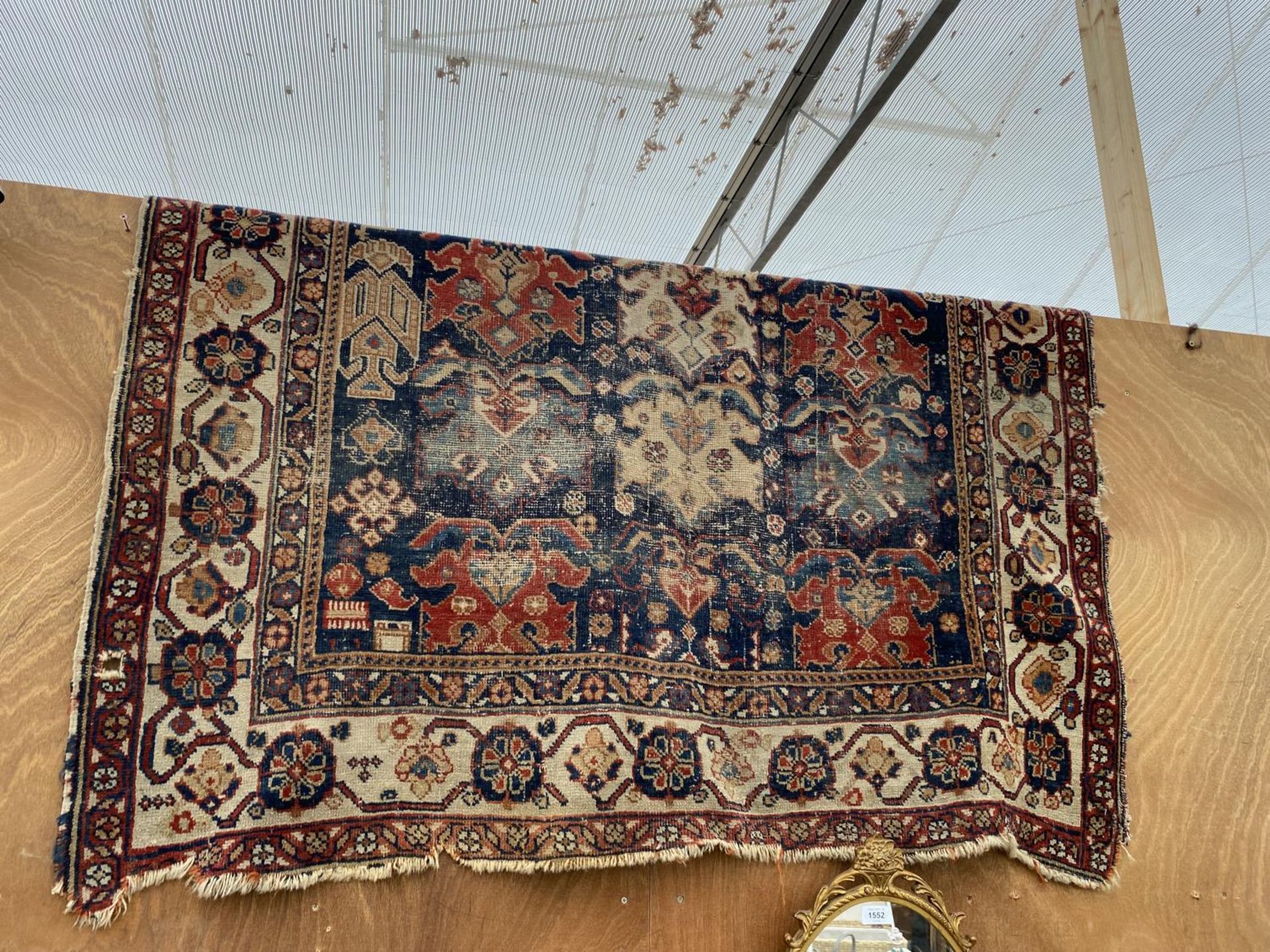 A VINTAGE PATTERNED FRINGED RUG