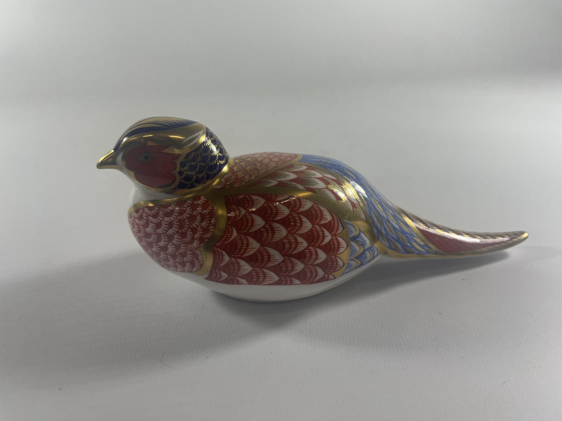 A ROYAL CROWN DERBY PHEASANT PAPERWEIGHT WITH SILVER STOPPER