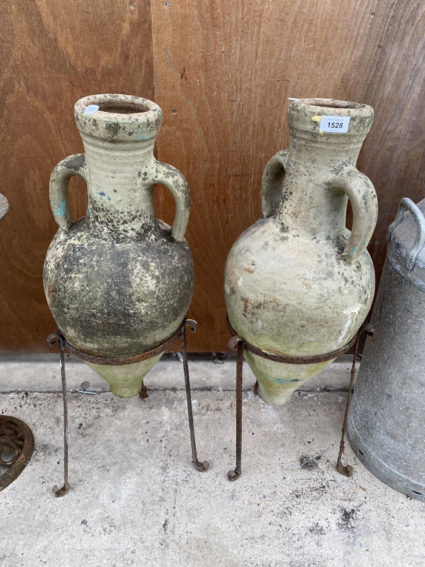 A PAIR OF METAL PLANT POT HOLDERS COMPLETE WITH TWO TERRACOTTTA URNS (H:79CM)