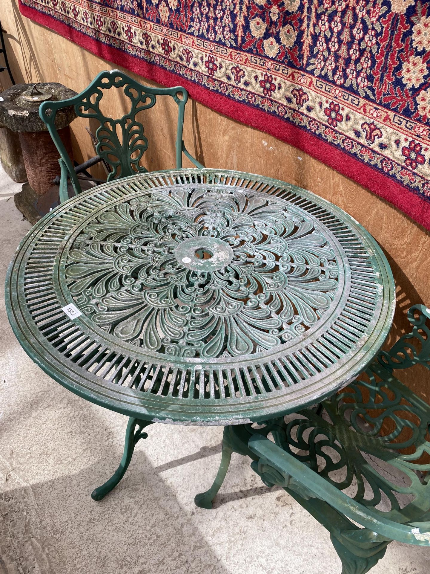 A CAST ALLOY BISTRO SET COMPRISING OF A ROUND TABLE AND TWO CARVER CHAIRS - Image 2 of 3