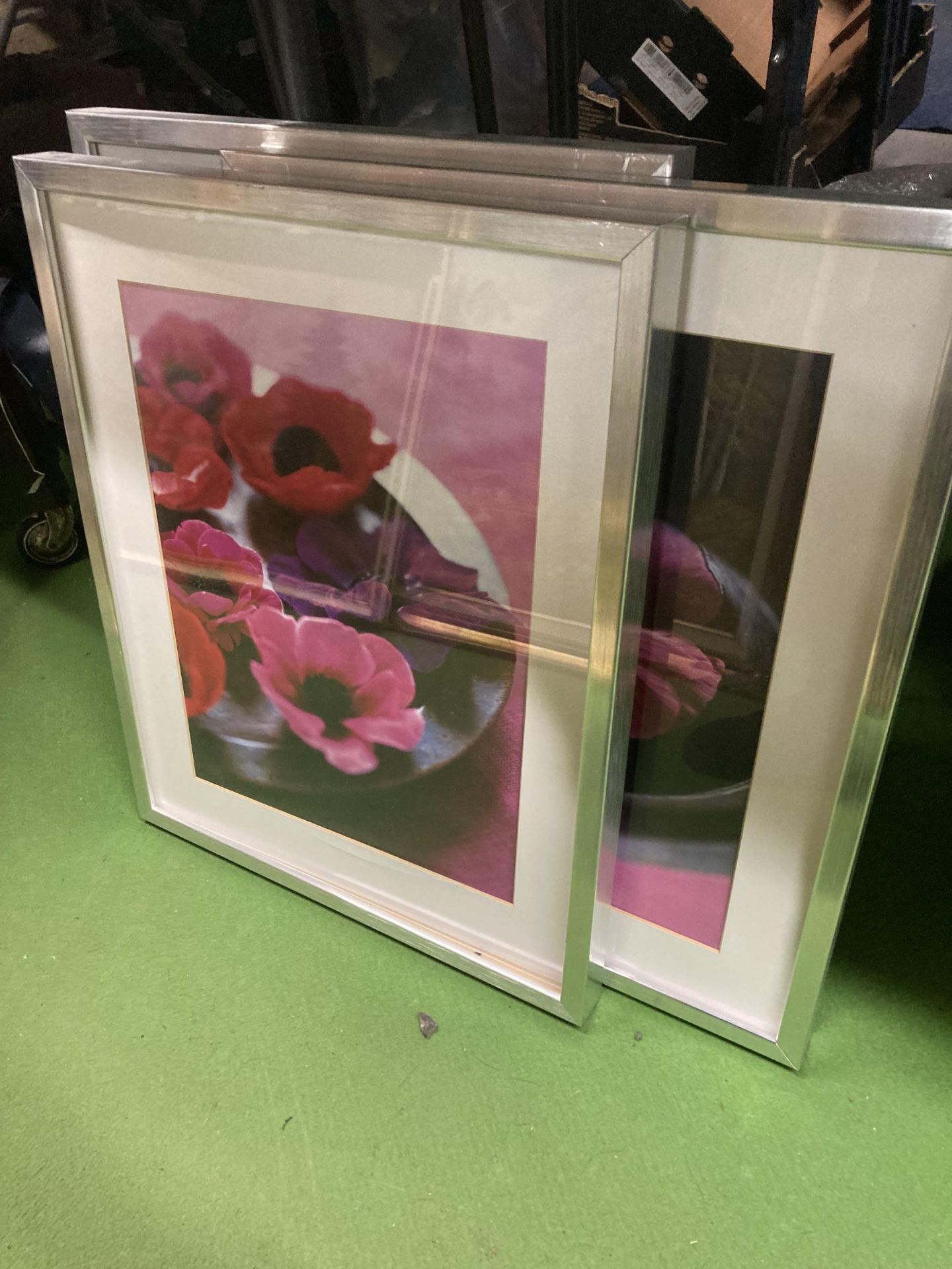 THREE MODERN FLORAL PRINTS IN SILVER FRAME