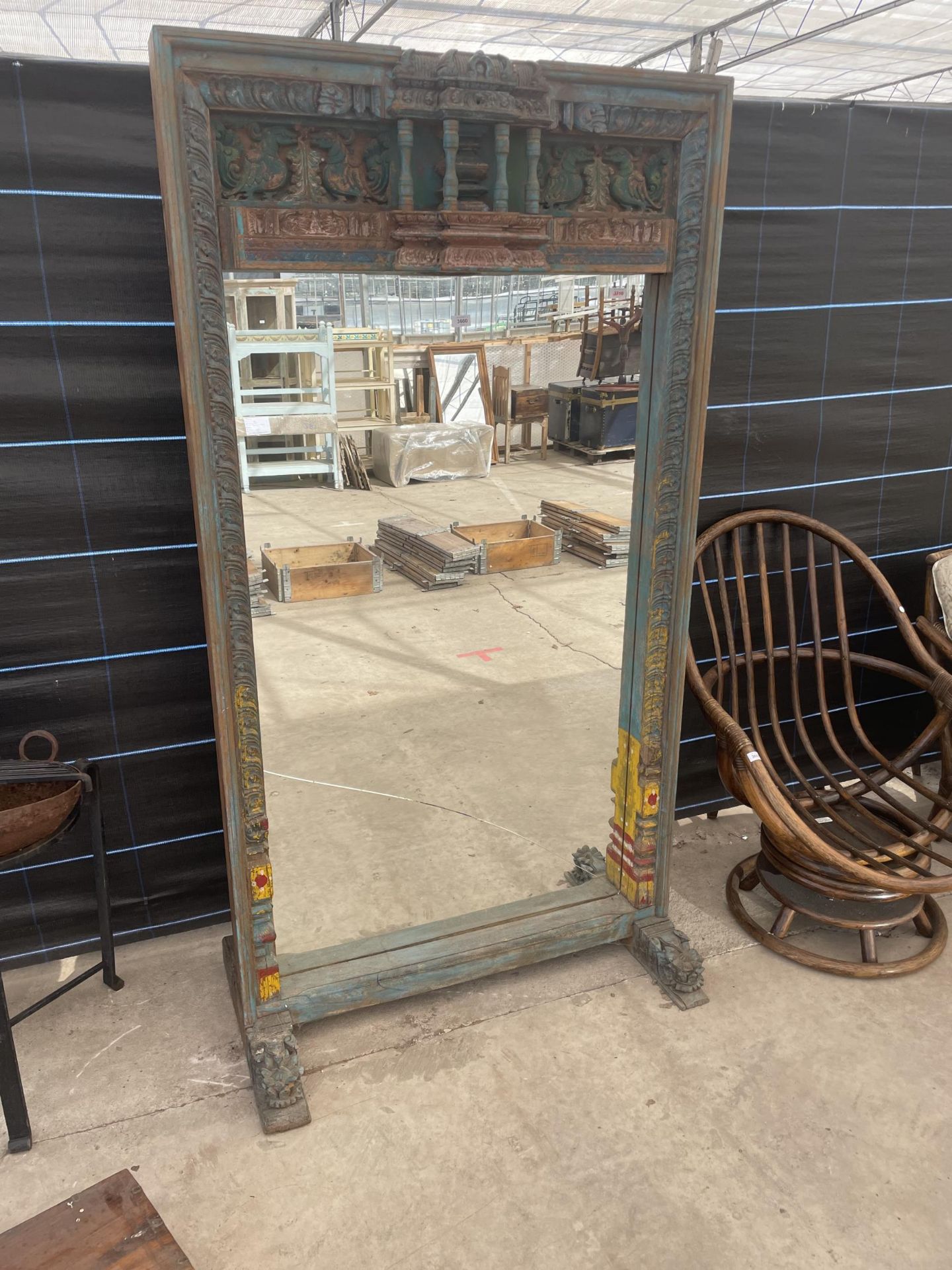 AN INDIAN HARDWOOD BLUE PAINTED FREESTANDING MIRROR ON CARVED BASE, (CRACK IN MIRROR) 41.5 X 77"